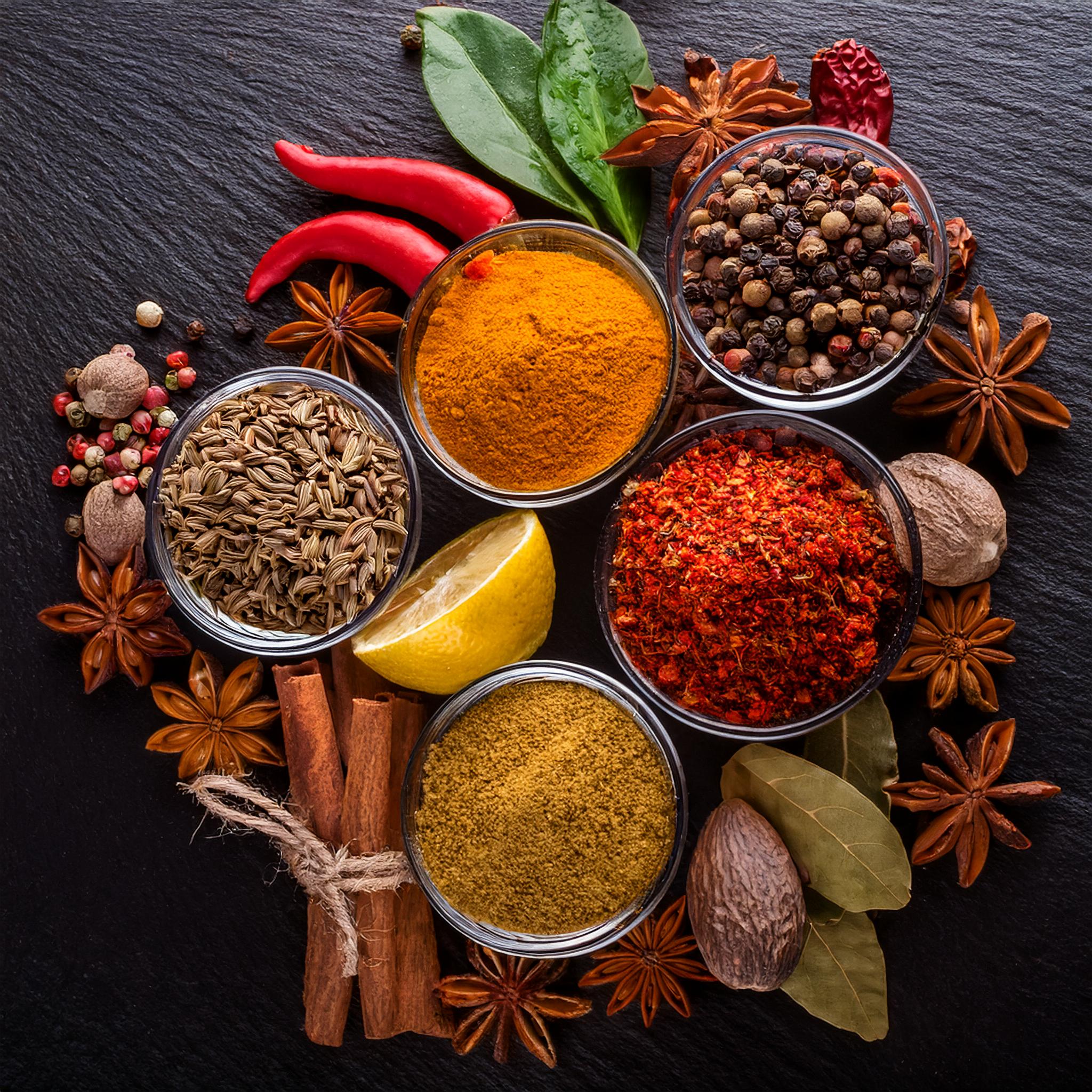 Assorted fresh herbs and spices on rustic wooden surface - vibrant aromatic spice collection